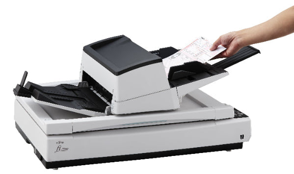 Document scanner with a person placing a document into it on a white background