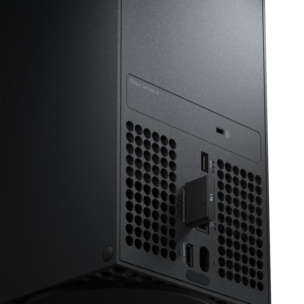 Close-up of a black computer tower with ventilation holes and brand logo.